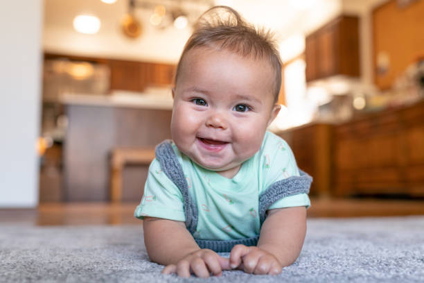 Baby laying on carpet floorings | Corvin's Furniture & Flooring